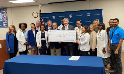 Congressman Bishop presents a ceremonial “big check” to Medical College of Georgia’s Dean David Hess, MD, in Albany, GA, representing FY23 federal funds for MCG's Southwest Campus